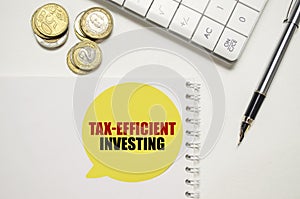 TAX-EFFICIENT INVESTING on yellow sticker on pen with coin photo