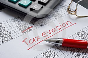 Tax evasion handwritten sign on the financial data.