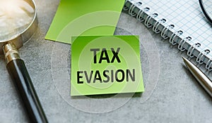 Tax Evasion Text on The Diary Paper for Writing on Gray Background