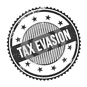 TAX EVASION text written on black grungy round stamp