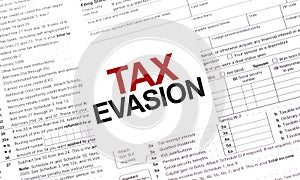 TAX EVASION words on paper sheet with documents