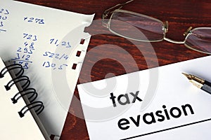 Tax evasion written on a paper. photo