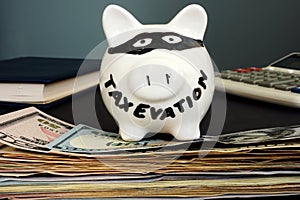 Tax evasion written on the piggy bank. photo