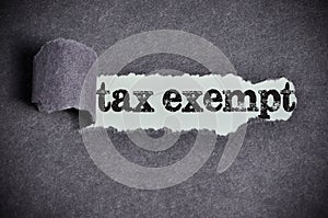 Tax exempt word under torn black sugar paper