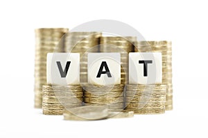 VAT (Value Added Tax) on gold coins on white backg photo