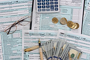 Tax form with dollars and spectacles and calculator