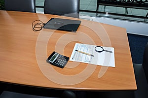 Tax forms 1040, calculator ,, pen, magnifier and laptop on the office desk