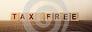Tax free text on a wooden cubes on wooden table background. Taxes, penalties and fees financial business concept