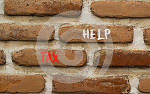 Tax help symbol. Concept words Tax help on beautiful brown brick wall on a beautiful brown brick wall background. Business,