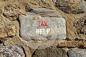 Tax help symbol. Concept words Tax help on beautiful stone on a beautiful stone wall background. Business, support and tax help