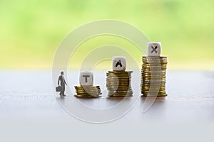 Tax increase concept and finances businessman and stacked coins