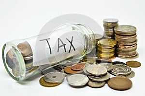 Tax lable in a glass jar with coins spilling out