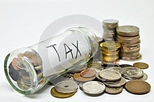 Tax lable in a glass jar with coins spilling out