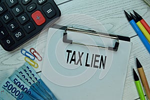 Tax Lien write on a paperwork isolated on office desk photo