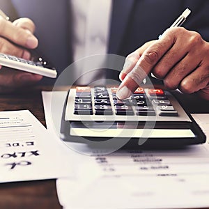 Tax payment concept. Business man using calculator for calculating taxes