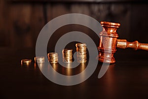 TAX payment concept. Stack of coins with judge gavel