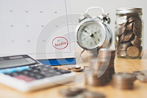 Tax payment season and finance debt collection deadline concept. Money coins stack, calendar, calculator and clock