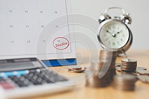 Tax payment season and finance debt collection deadline concept. Money coins stack, calendar, calculator and clock