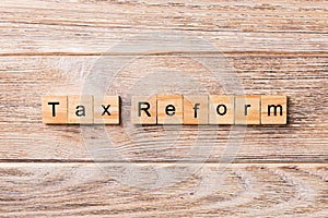 Tax reform word written on wood block. tax reform text on wooden table for your desing, concept