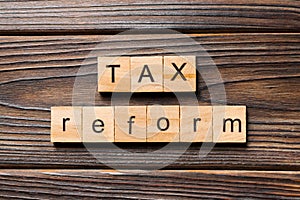 Tax reform word written on wood block. tax reform text on wooden table for your desing, concept
