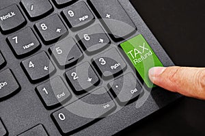 Tax refund button and finger.