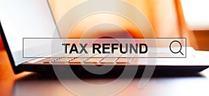 TAX REFUND - searching the Internet against the background of a laptop