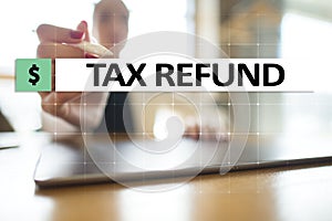 Tax refund text on virtual screen. Business and Finance concept.