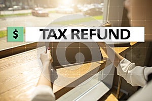 Tax refund text on virtual screen. Business and Finance concept.