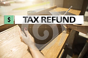 Tax refund text on virtual screen. Business and Finance concept.