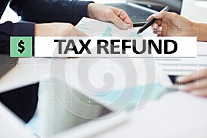 Tax refund text on virtual screen. Business and Finance concept.