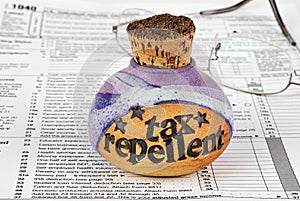 Tax repellent bottle and tax form photo