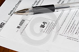 Tax reporting forms with black pen