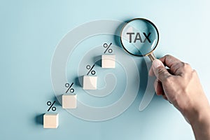 Tax staircase Interest rate percent and dividend. Magnifier focus to tax calculating income and return on investment in percentage