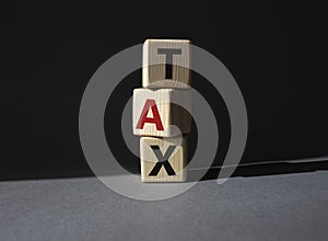 Tax symbol. Wooden cubes with word Tax. Beautiful grey background. Business and Finace and Tax concept. Copy space