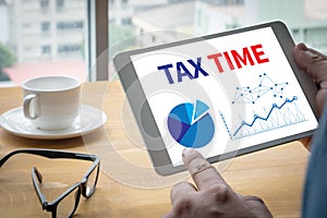 TAX TIME Business team hands at work with financial reports