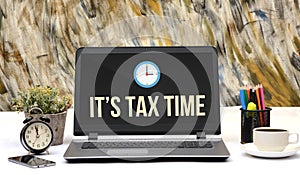 It is Tax Time with clock icon on laptop screen