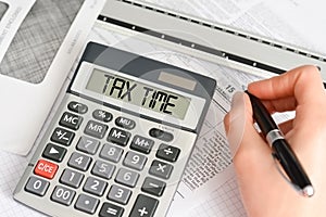 Tax time concept with hand calculator and tax form