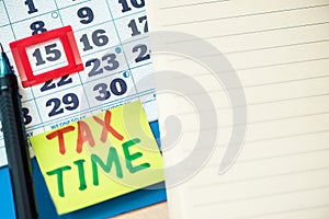 Tax Time concept on the sticky note paper on a calendar with  deadline date