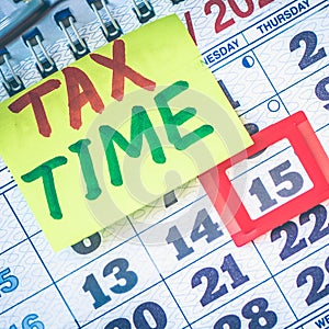 Tax Time concept on the sticky note paper on a calendar with  deadline date