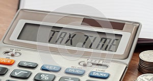 Tax Time word on calculator. Business and tax concept. Time to pay tax in year.