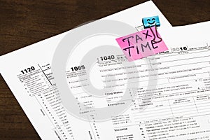 Tax time written on a bright sticker note paper clip for a tax