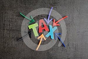 Tax typography text concept, magnet arrows pointing to the word