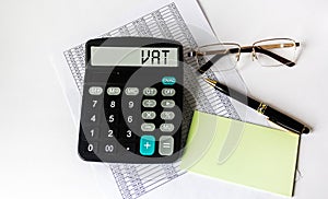 Tax VAT season financing concept written on the display of a calculator that lies