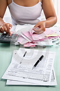 Tax from and woman calculating bills photo