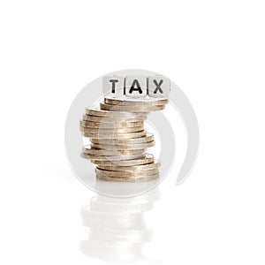 TAX word cube on the silver coins stcking