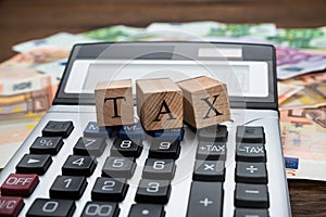 Tax Word On Wooden Blocks Over Calculator