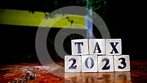 tax writing on wooden blocks as background