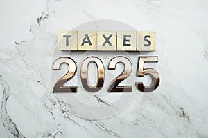 Taxes 2025 alphabet letter on marble background