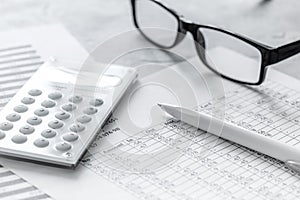 Taxes accounting with calculator in office work space on stone desk background top view