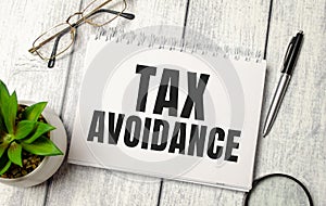 Taxes Avoidance - written on paper notebook and office supplies